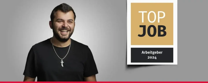 Banner mit einem Mitarbeiter und dem TOP JOB-Siegel.