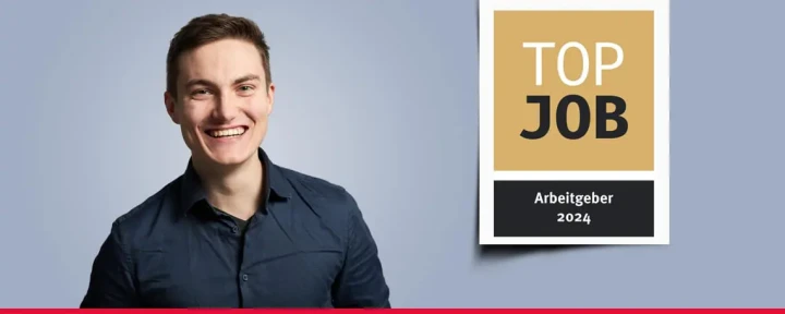 Banner mit einem Mitarbeiter und dem TOP JOB-Siegel.